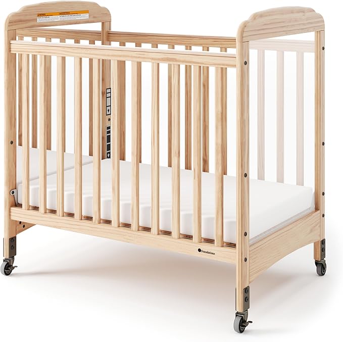 Foundations Serenity Compact Daycare Crib, Fixed Side, Features Mirrorview End Panels and Slatted Side Panels, Durable Wood Construction, Includes 3” InfaPure Foam Mattress (Natural)