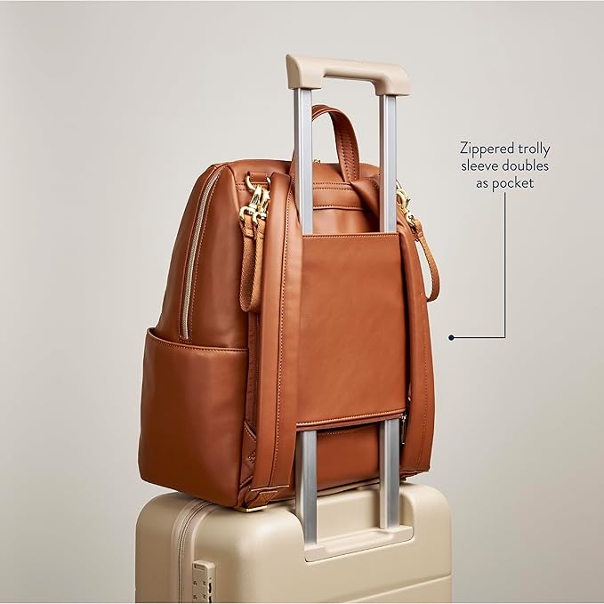 Itzy Ritzy Eras Diaper Bag Backpack – Large Capacity Backpack Diaper Bag Featuring Sleek Design, 15 Pockets, Changing Pad, Stroller Straps, and Luggage Sleeve (Cognac)